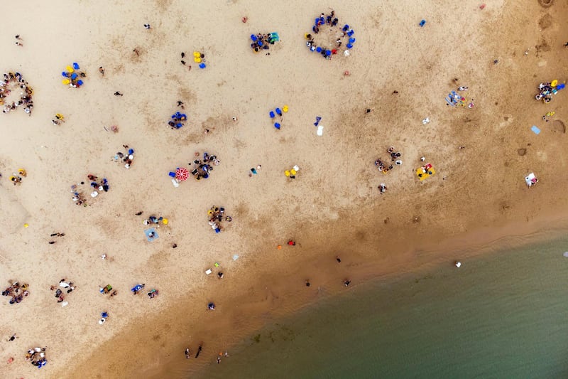 Israelis enjoy the beach of the Mediterranean during a heat wave as Covid-19 restrictions ease around the country, in Ashkelon, Israel. Reuters