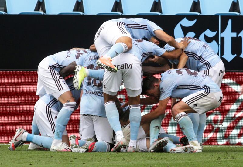 Celta Vigo's Iago Aspas is mobbed by teammates after scoring the late equaliser. Reuters