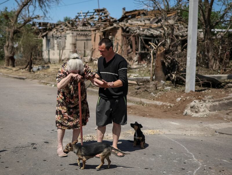 A 81-year-old resident of the town of Druzhkivka, in the Donetsk region of Ukraine, cries as she leaves her home, which was destroyed by a Russian military strike. Reuters