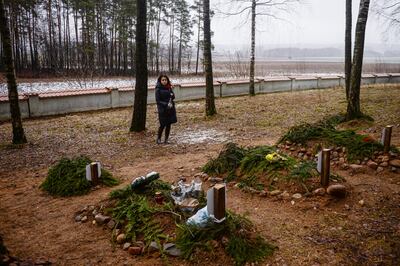 Urszula Glensk, a Wroclaw university professor, pays her respects in January by the graves of three migrants who died at the border area and an unborn baby who died during a miscarriage. The deceased are buried at the Muslim cemetery in Bohoniki, Poland. Getty Images