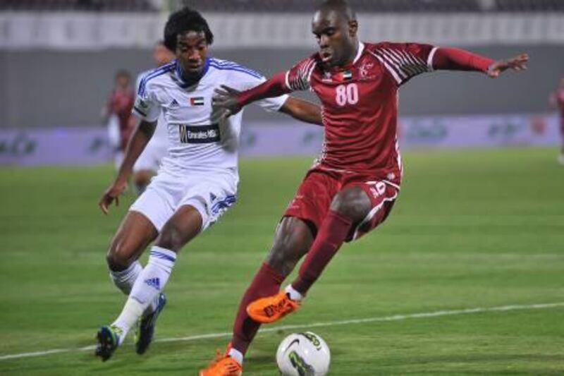 (right) Al Wahda's midfileder #80 Hugo Henrique fends off a defender from Al Nasr during game action on Tuesday, February 14, 2012. ABDULLATEEF ALMARZOUQI / Al Ittihad