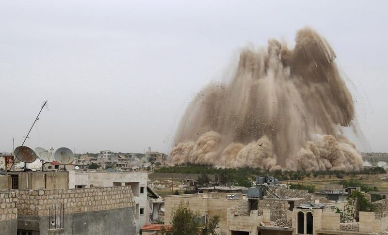 Debris rises in what Free Syrian Army fighters and Islamist rebels said was an operation to strike the Al-Sahaba military checkpoint and remove forces loyal to Syria's President Bashar Al Assad in Maarat Al Nouman, Idlib province on May 5. Rasem Ghareeb / Reuters