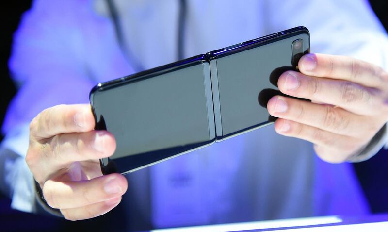 A member of the media holds a Samsung Galaxy Z Flip. AFP