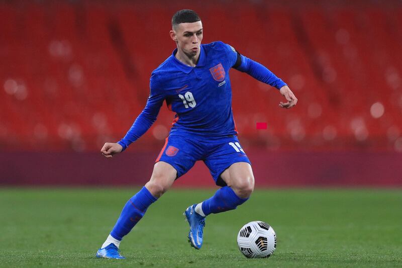 Englands's midfielder Phil Foden runs with the ball during the FIFA World Cup Qatar 2022 qualification football match between England and San Marino at Wembley Stadium in London on March 25, 2021. (Photo by Adam Davy / POOL / AFP) / NOT FOR MARKETING OR ADVERTISING USE / RESTRICTED TO EDITORIAL USE