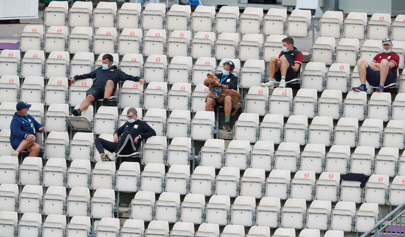 Ground staff sit in the spectators' gallery with a dog during the England- Pakistan cricket match at the Ageas Bowl, Southampton, Britain.  Reuters