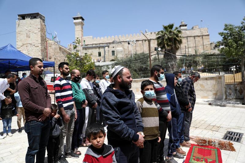 Palestinians attend Friday prayers during Ramadan outside the Ibrahimi Mosque in the West Bank city of Hebron. EPA