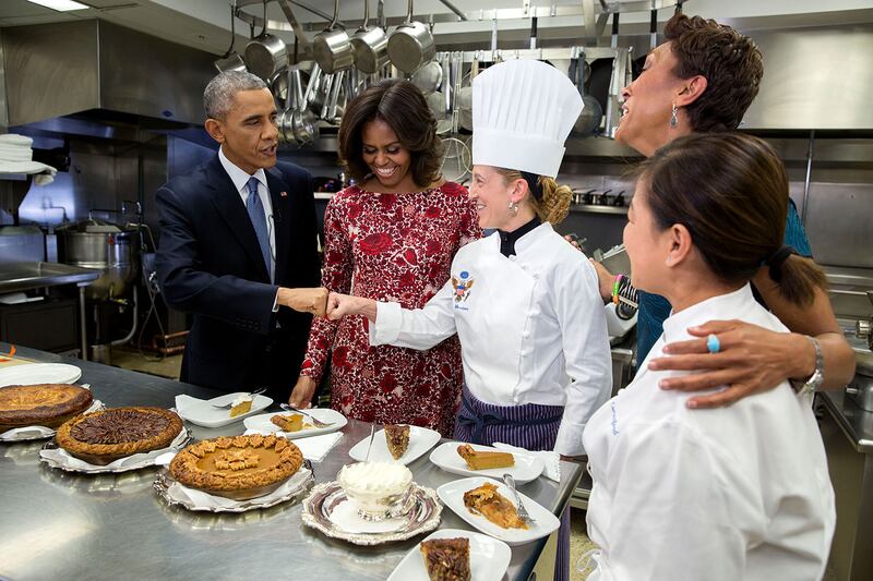 Barack Obama fist-bumps executive pastry chef Susie Morrison after sampling pies with his wife Michelle Obama, ABC anchor Robin Roberts and Ms Comerford during an interview about Thanksgiving in the White House kitchen in 2014. Photo: Official White House Photo / Pete Souza