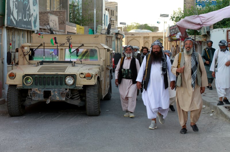 Members of the militia loyal to Ismail Khan, a former Mujahideen commander, walk in the city of Herat after security forces took back control following fighting between Taliban and Afghan security forces. AP