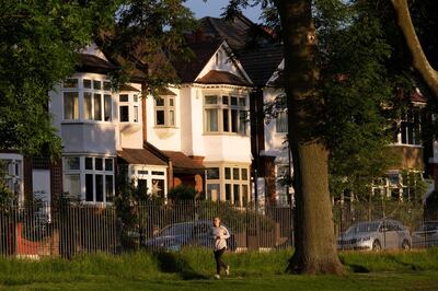 In evening sunshine, a woman runner jogs past suburban houses in the borough of Lambeth, on 7th June 2021, in south London, England. (Photo by Richard Baker / In Pictures via Getty Images)