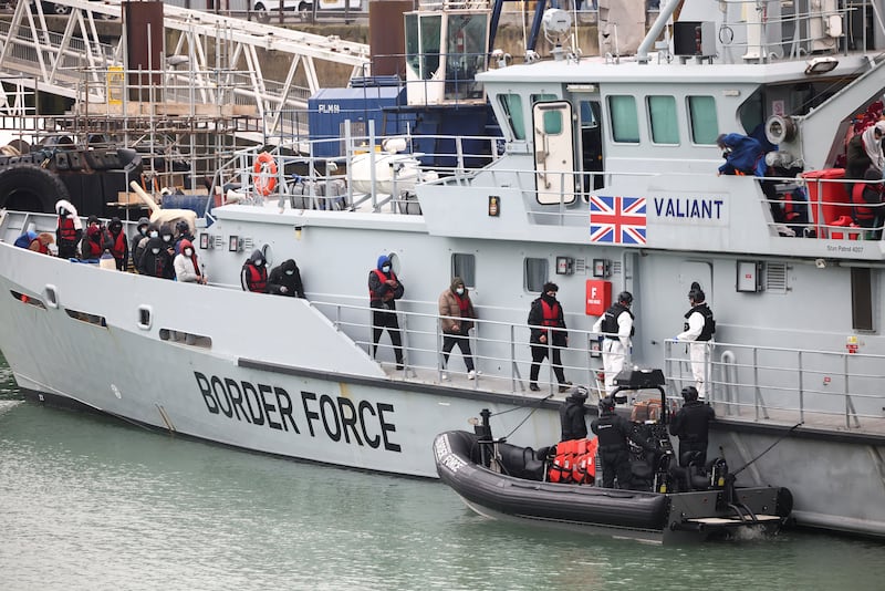 Migrants on board a Border Force rescue boat line up to disembark at Dover harbour after crossing the Channel. Reuters