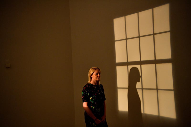 A woman poses with Danish-Icelandic artist Olafur Eliasson's work 'Window Projection' (1991) during a press preview at the Tate Modern in London, Britain, 09 July 2019. Photo: EPA