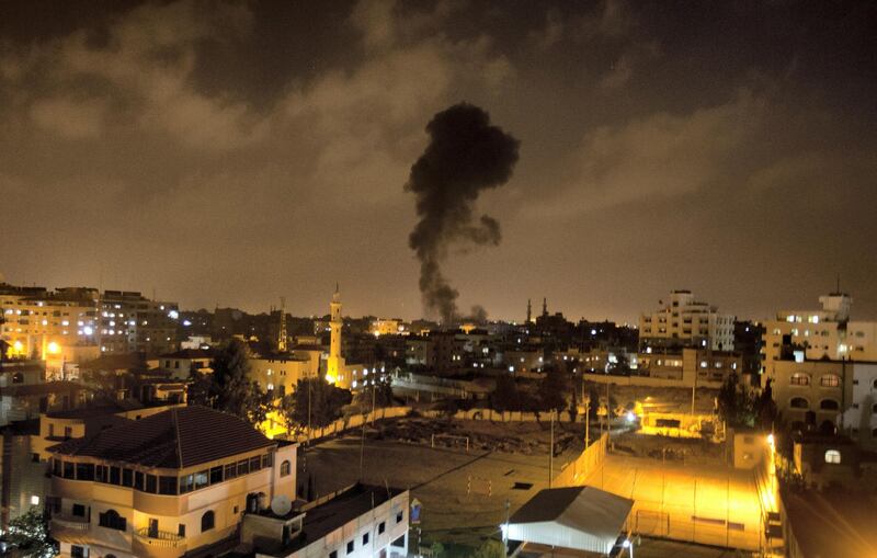 Smoke rises after an Israeli missile strike hit Gaza City on July 07, 2014.  Two Palestinian fighters were killed and another wounded late Sunday by an Israeli drone strike in the Gaza Strip, emergency services said.  The victims were among a group of armed militants who were targeted by the Israeli drone east of Bureij refugee camp, near central Gaza's border with the Jewish state, witnesses said.   AFP PHOTO / MAHMUD HAMS / AFP PHOTO / MAHMUD HAMS