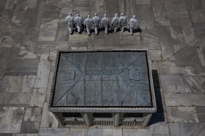 Employees from Fatih municipality disinfect the courtyard of the Suleymaniye Mosque on the last day of Eid Al Fitr in Istanbul, Turkey. Getty Images