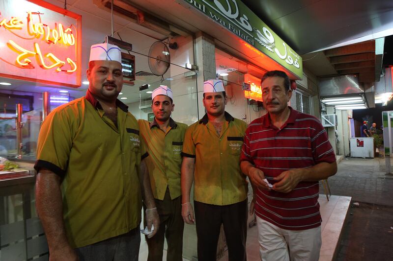 SHARJAH, UNITED ARAB EMIRATES Ð July 26: Salem Khalil Al Sheikh (right) from Jordan with his staff from Egypt at his Foul Wa Falafel restaurant in Sharjah. This restaurant opens 24 hours a day. He came to UAE in 1999. Most of the motorist order shawarma or some other food while sitting in the car. His two sons and two daughters also living in the Sharjah. Generally customers comes in the evening while going to home from office. Name of the staff from left- Mohamed Saeed Abdul, Mohamed Ahmed Mustafa and Ali Fohad Ibrahim (all from Egypt). (Pawan Singh / The National) For News. A Week In Feature

