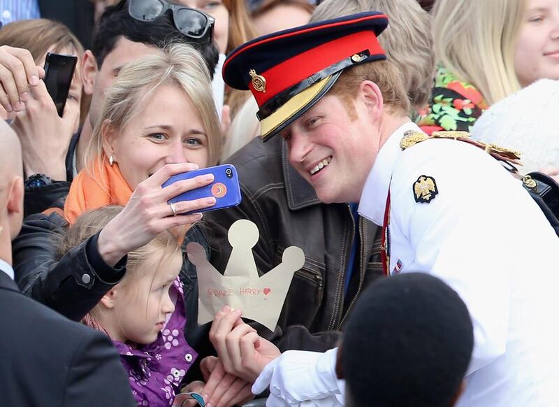 A member of the public takes a selfie with Prince Harry as he meets locals in Freedom Square on May 16, 2014 in Tallinn, Estonia. Prince Harry is on a two day trip to Estonia. Chris Jackson / Getty Images 