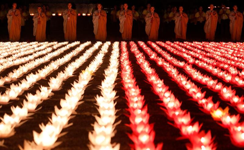 Buddhist monks pray at a candle light procession during the Vesak Day at Tam Chuc Pagoda in Ba Sao town, Vietnam. Reuters