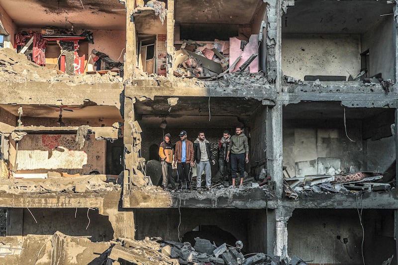 Palestinians check a half-destroyed building after an Israeli bombardment on Rafah, in the southern Gaza Strip. AFP