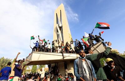 Protesters celebrate after reaching Sudan's Nile-side presidential palace at the heart of Khartoum. Reuters.
