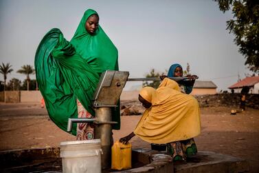 Camp dwellers pump water from a well at Malkohi refugee camp in Jimeta, Adamawa State, Nigeria. AFP 
