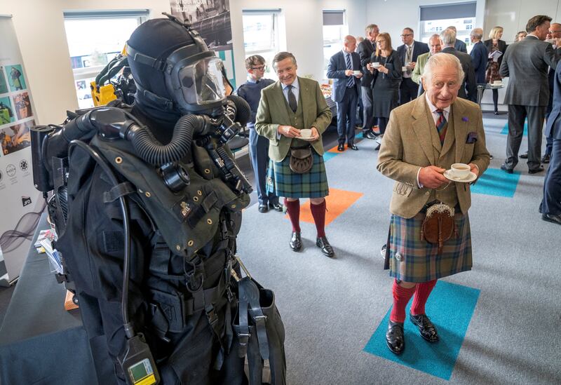 Britain's King Charles III looks at diving apparatus during his visit to the Global Underwater Hub in Westhill, Aberdeenshire. Reuters