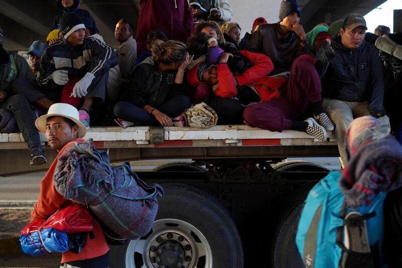 Migrants travel on top of a truck as they make their way to Irapuato from Queretaro, Mexico. Reuters
