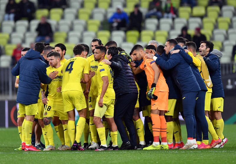 Villarreal players in a huddle before the penalty shootout. EPA