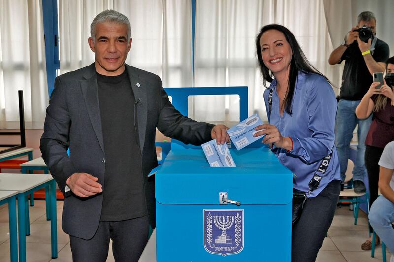 Israeli centrist former television anchor Yair Lapid, the prime minister's main challenger, and his wife Lihi cast their votes at a polling station in Tel Aviv. AFP