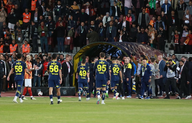 Fenerbahce's players leave the pitch minutes into the Turkish Super Cup match against Galatasaray. Fenerbahce, who fielded their Under-19 team, staged a protest over various issues with Turkey’s football authorities, forcing the game to be abandoned and forfeited. EPA