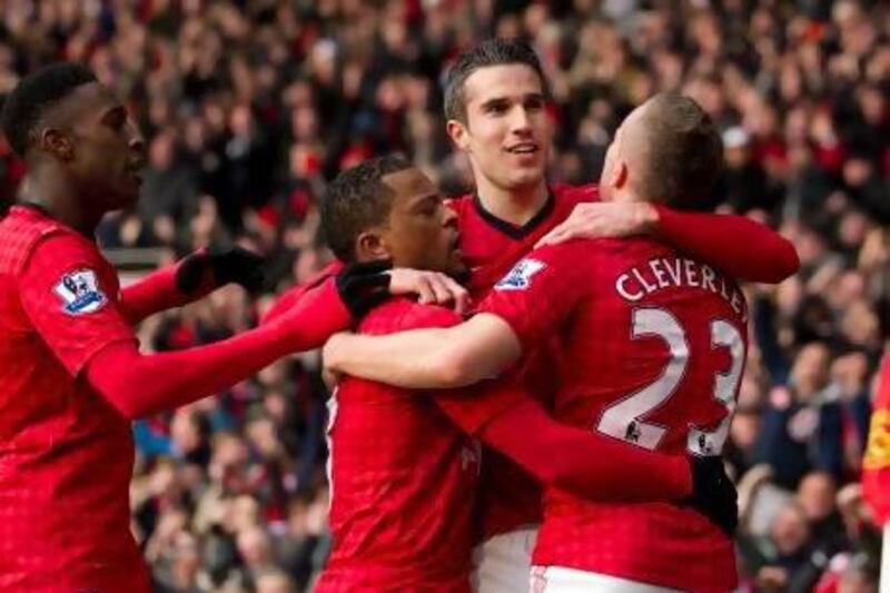 Manchester United's Robin van Persie, second right, celebrates with teammates after scoring against Liverpool. Jon Super / AP Photo