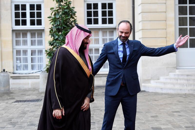 French Prime Minister Edouard Philippe welcomes Saudi Arabia's Crown Prince Mohammed bin Salman upon his arrival at the Hotel de Matignon in Paris. Eric Feferberg / AFP