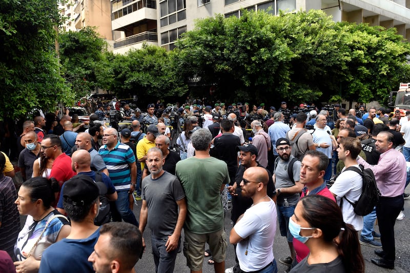 Lebanese bank customers stand near the bank where the armed man took customers and employees hostage. EPA