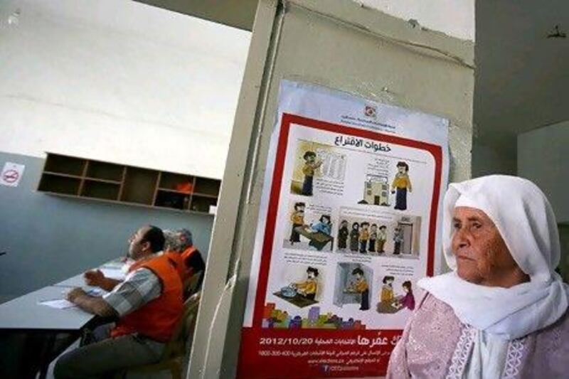 A Palestinian woman waits to vote for the municipal elections at a polling station yesterday.