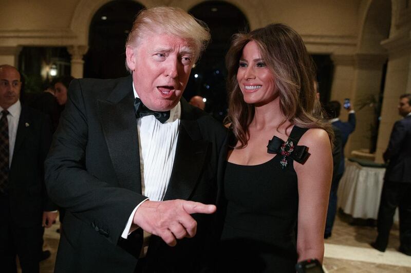 Melania Trump looks on as president-elect Donald Trump talks to reporters during a party at Mar-a-Lago in Palm Beach, Florida on December 31, 2016. Evan Vucci / AP Photo