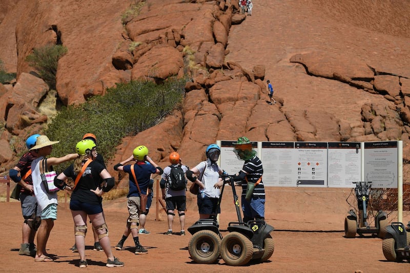 Hundreds of tourists flocked to Uluru for one last chance to scale the sacred red monolith ahead of a climbing ban. AFP