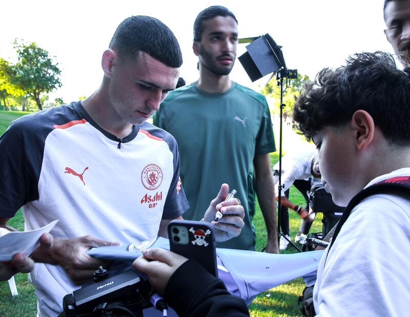 Phil Foden of Manchester City signs autographs.