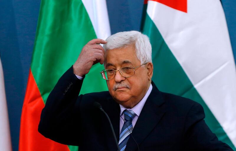 Palestinian Authority president Mahmoud Abbas scratches his head during a joint press conference with the visiting Bulgarian president at the Palestinian Authority headquarters in the West Bank city of Ramallah on March 22, 2018. / AFP PHOTO / ABBAS MOMANI