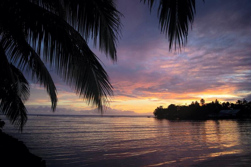 The sun sets at Teahupoo, Tahiti, on August 28, 2019. (Photo by brian bielmann / AFP)