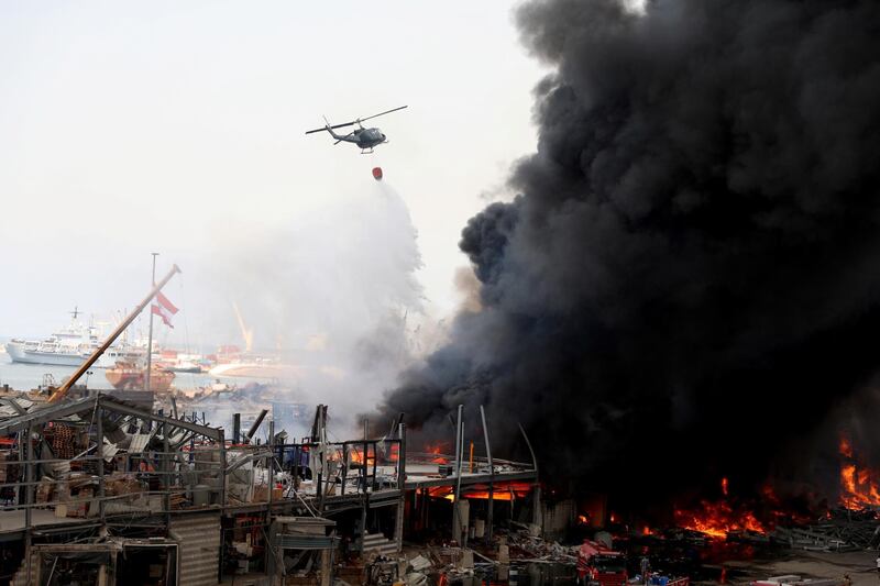 A helicopter tries to put out a fire that broke out at Beirut's port area. Reuters