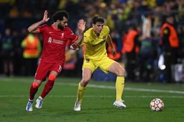 Liverpool's Egyptian midfielder Mohamed Salah (L) vies with Villarreal's Spanish defender Pau Torres during the UEFA Champions League semi final second leg football match between Liverpool and Villarreal CF at La Ceramica stadium in Vila-real on May 3, 2022.  (Photo by Paul ELLIS  /  AFP)