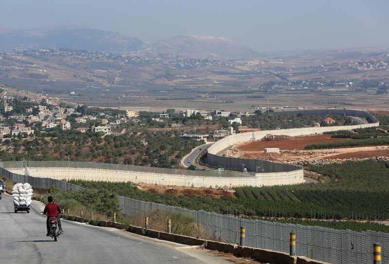 A man rides a motorbike in Adaisseh village, near the Lebanese-Israeli border