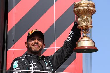 Winner British Formula One driver Lewis Hamilton of Mercedes-AMG Petronas celebrates on the podium after the Formula One Grand Prix of Great Britain at the Silverstone Circuit, in Northamptonshire, Britain, 18 July 2021.   EPA / Lars Baron  /  POOL