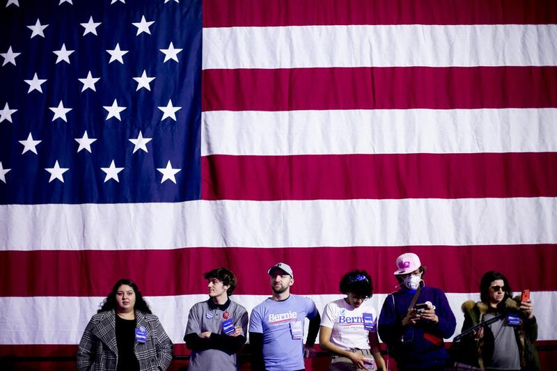 Attendees stand in front of an American flag during the Get Out The Vote rally with Bernie Sanders on March 6, 2020. Bloomberg