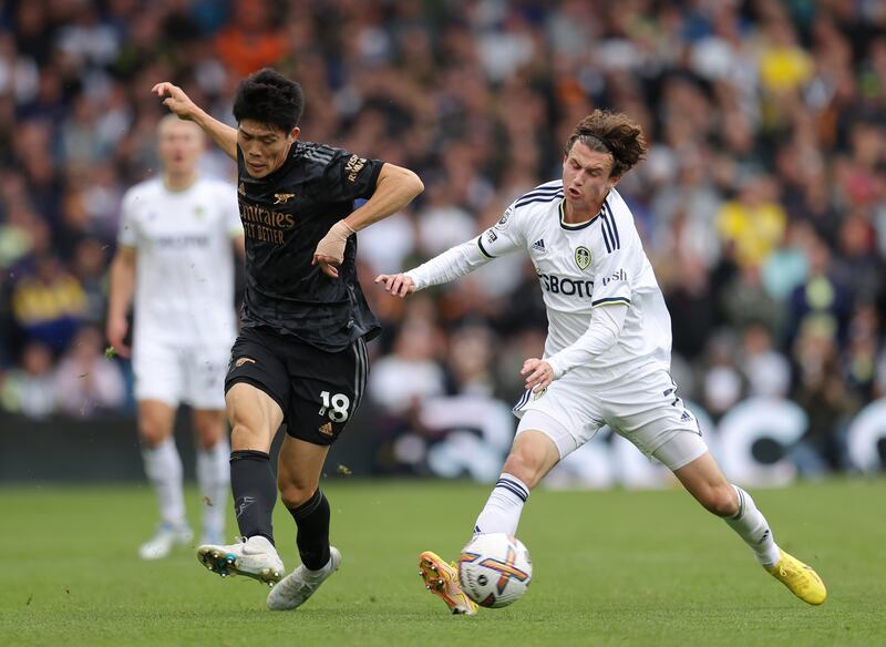 Takehiro Tomiyasu of Arsenal is challenged by Brenden Aaronson of Leeds United. Getty