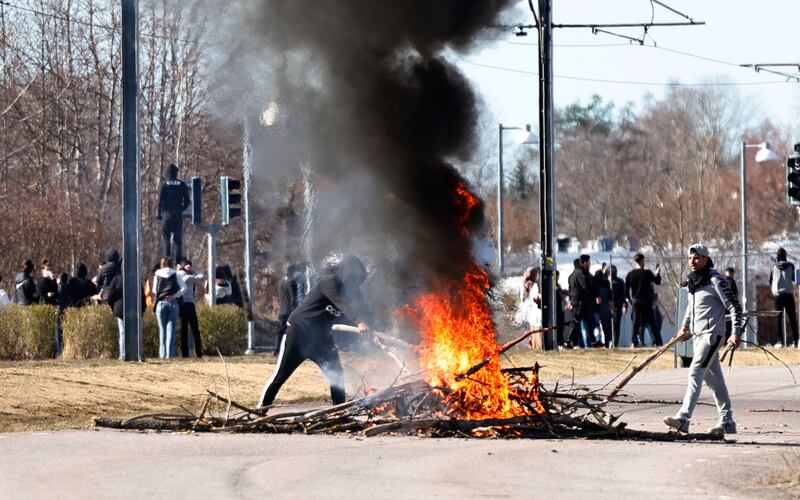 Protesters block a road with a bonfire in Norrkoping, eastern Sweden. AP