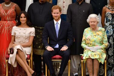 Britain's Queen Elizabeth II, Prince Harry and Meghan Markle. Reuters