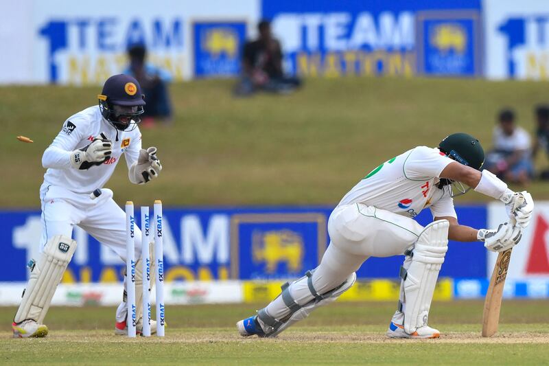Pakistan's Imam-ul-Haq is clean bowled as Sri Lanka's wicketkeeper Niroshan Dickwella watches. AFP