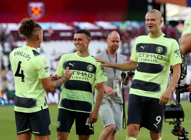 Manchester City's Kalvin Phillips, Phil Foden and Erling Haaland on the pitch after the full-time whistle. PA