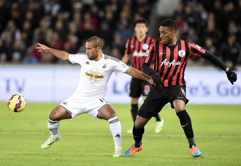 Swansea City''s Wayne Routledge, left, tries to control the ball against Queens Park Rangers' Leroy Fer during Swansea's 2-0 Premier League win at the Liberty Stadium on Tuesday night. Rebecca Naden / Reuters