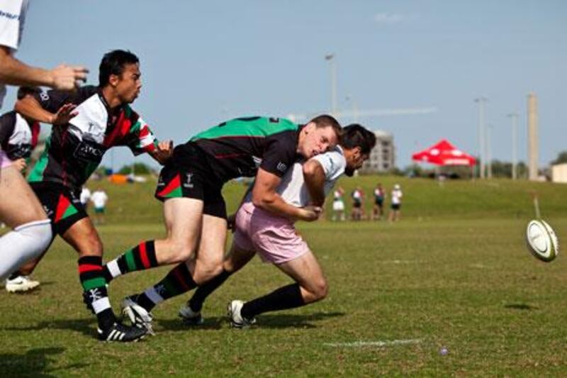 Michael Mc Farlane of the Abu Dhabi Harlequins tackles a Frog's player during a game on Friday at Zayed Sports City.