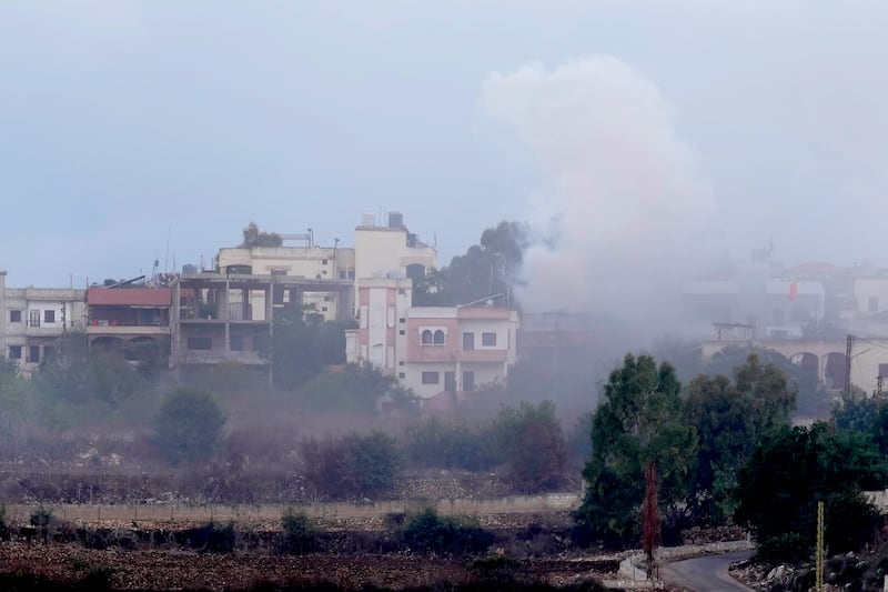 Smoke rises from artillery shell that hit the houses of Aita al-Shaab a Lebanese border village with Israel, south Lebanon, Sunday, Oct.  15, 2023.   (AP Photo / Hussein Malla)